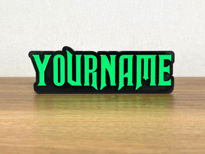Picture of a wicked musical name sign on a wooden desk or bedroom table